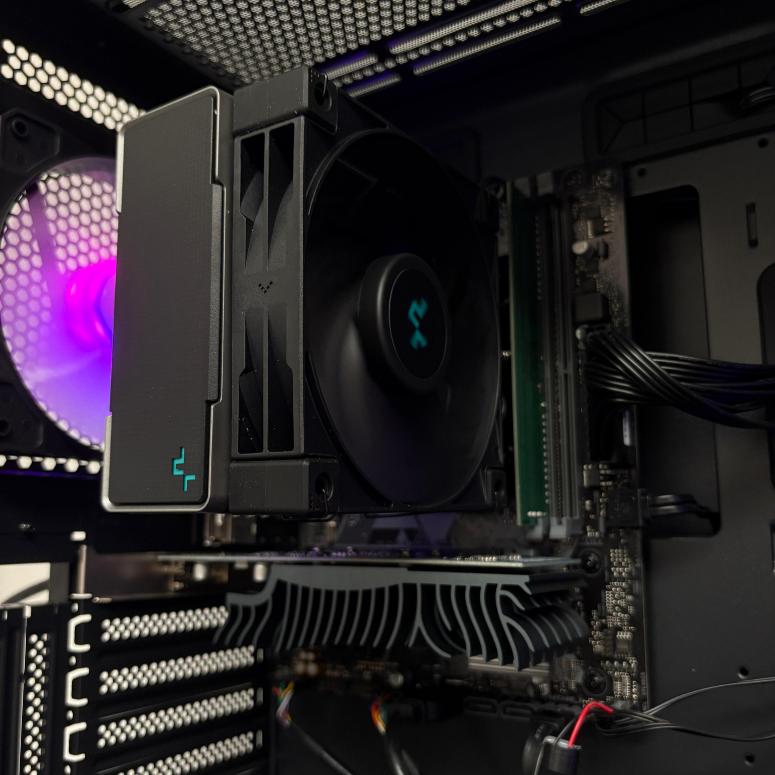 Close-up of a computer motherboard with cooling components inside a PC case.